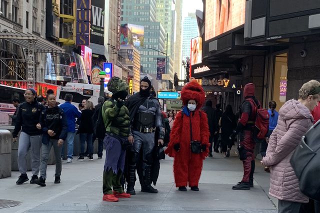 A photo of a Times Square Elmo wearing a mask